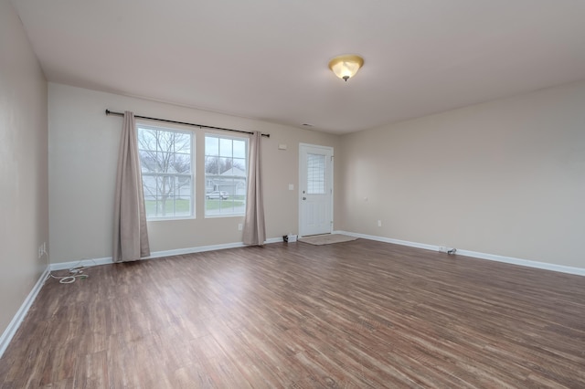 spare room with dark hardwood / wood-style flooring