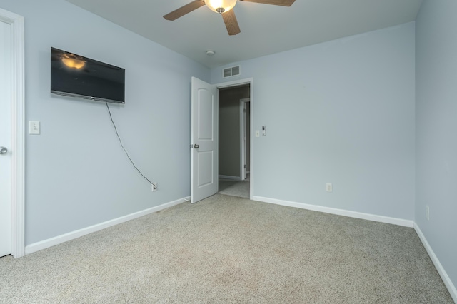 spare room with carpet and ceiling fan