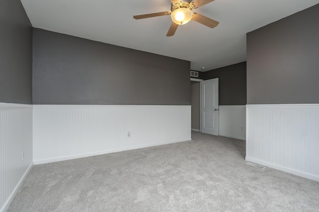 carpeted empty room with ceiling fan