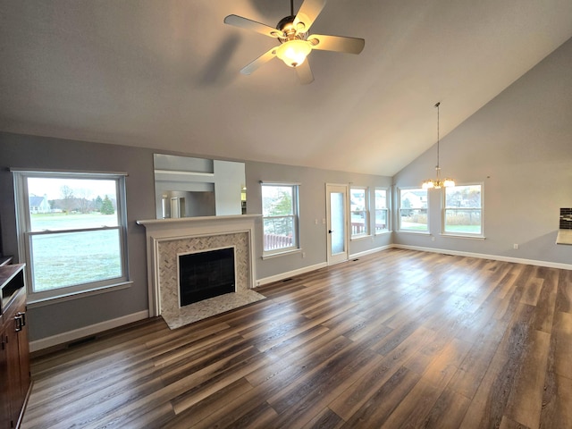 unfurnished living room featuring a premium fireplace, dark hardwood / wood-style floors, ceiling fan with notable chandelier, and high vaulted ceiling