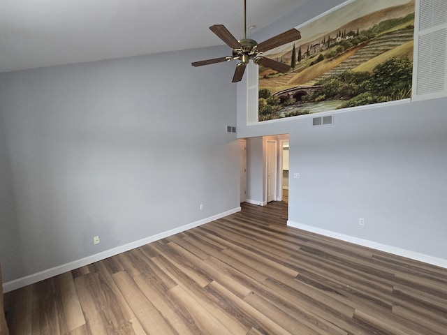 unfurnished room with hardwood / wood-style flooring, ceiling fan, and a high ceiling