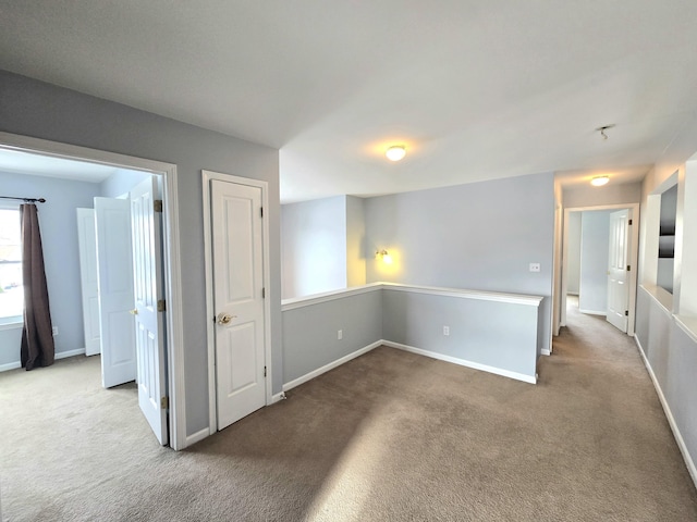 spare room featuring light colored carpet