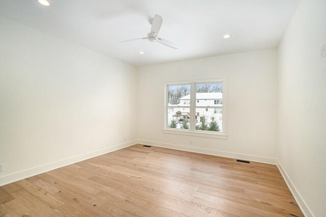 spare room with ceiling fan and light hardwood / wood-style floors