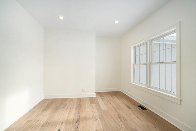 spare room featuring light wood-type flooring