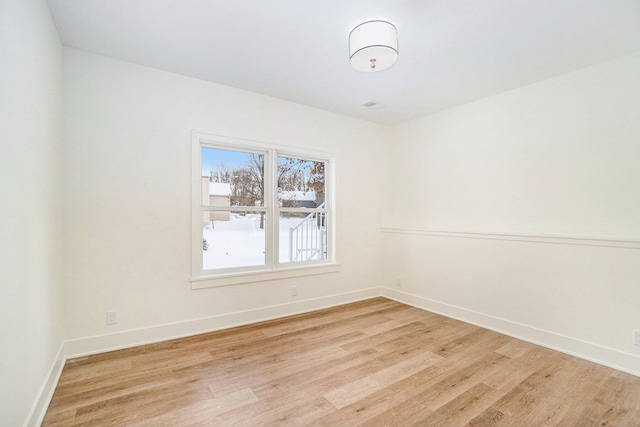 spare room featuring light hardwood / wood-style floors