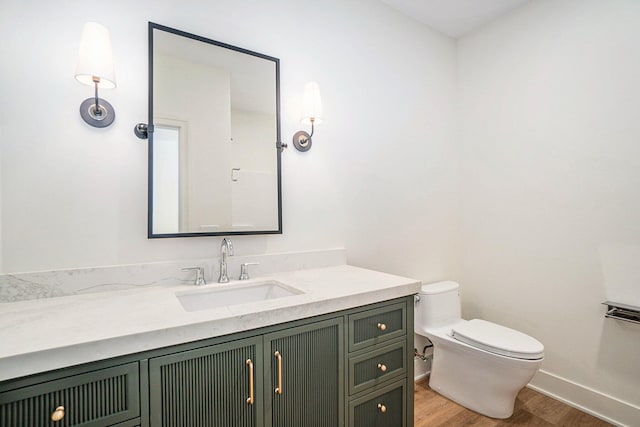 bathroom featuring hardwood / wood-style flooring, vanity, and toilet