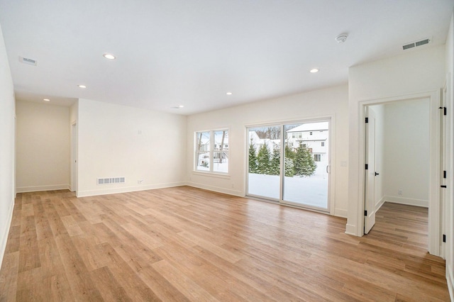 spare room with light wood-type flooring