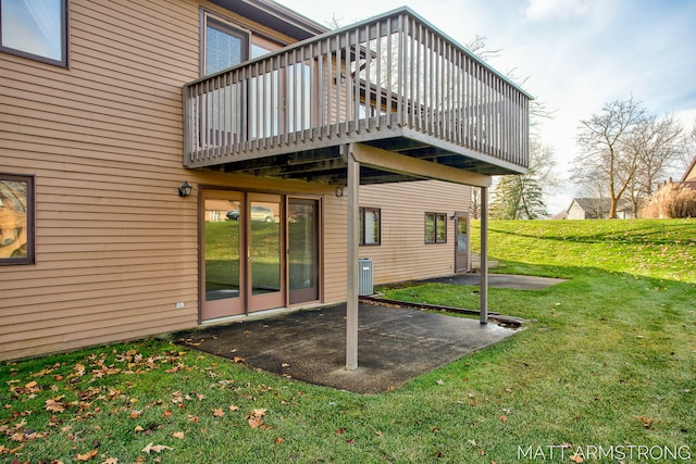 back of house featuring central air condition unit, a patio area, and a lawn