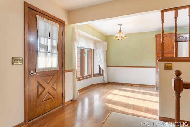 entryway featuring a chandelier and light hardwood / wood-style floors