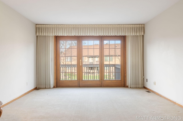 unfurnished room featuring light carpet