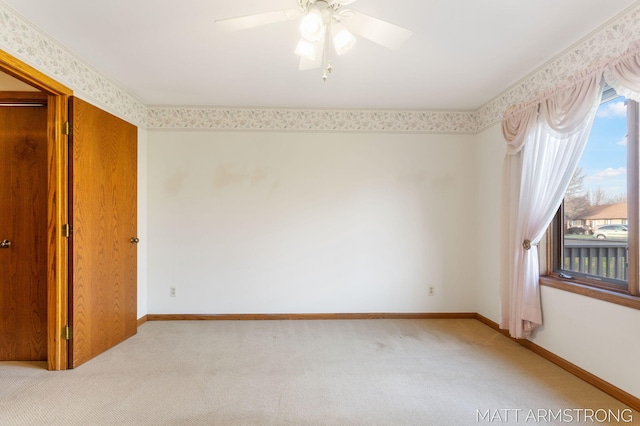 carpeted empty room with ceiling fan