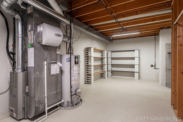 basement featuring gas water heater and heating unit