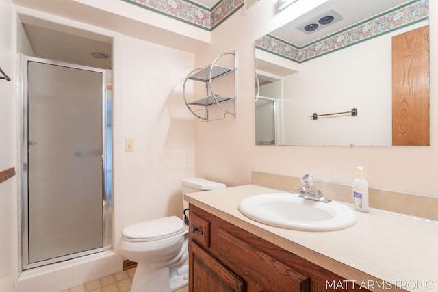 bathroom with vanity, an enclosed shower, and toilet