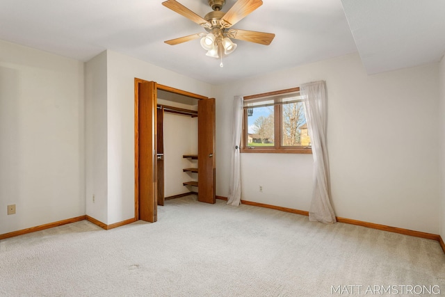 unfurnished bedroom featuring light carpet, a closet, and ceiling fan