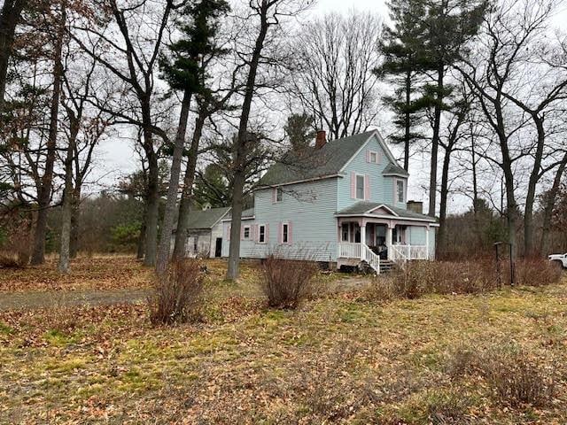 view of side of home featuring a porch