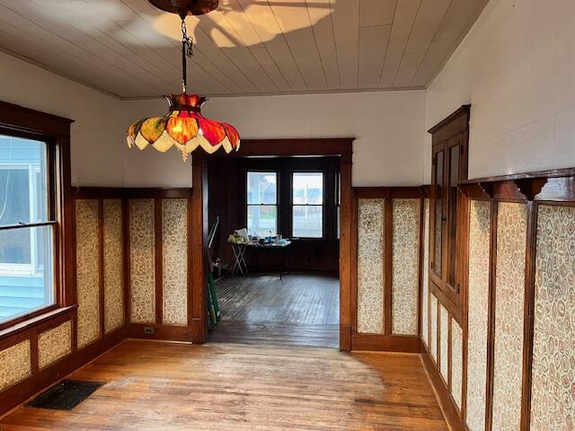 interior space with hardwood / wood-style floors, french doors, and wooden ceiling