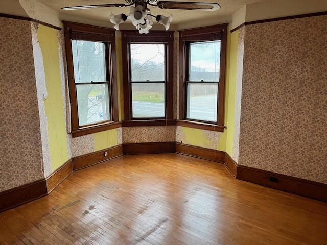 empty room featuring ceiling fan and light hardwood / wood-style floors