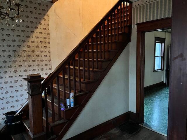 staircase featuring wood-type flooring