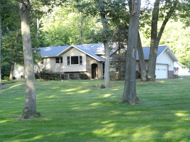 bi-level home featuring a front yard and a garage