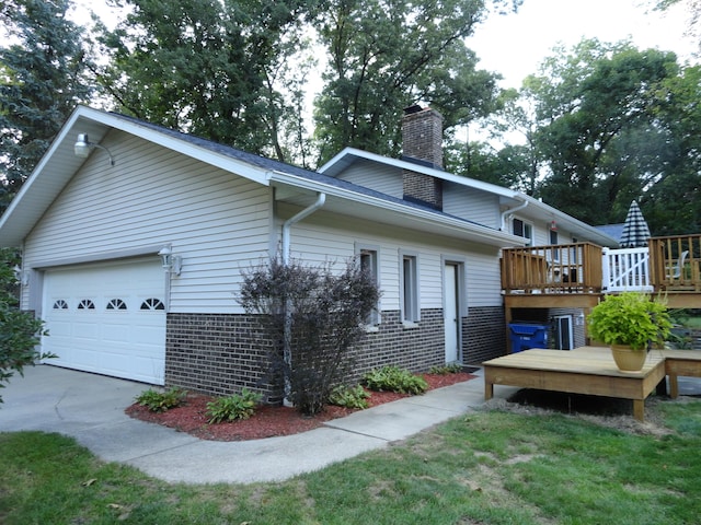 exterior space featuring a wooden deck and a garage