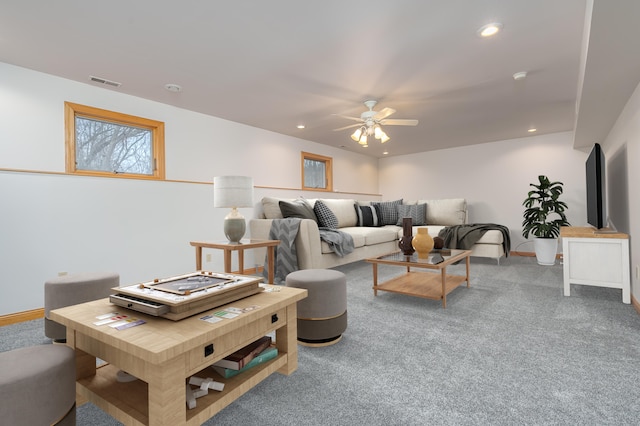 carpeted living room with ceiling fan