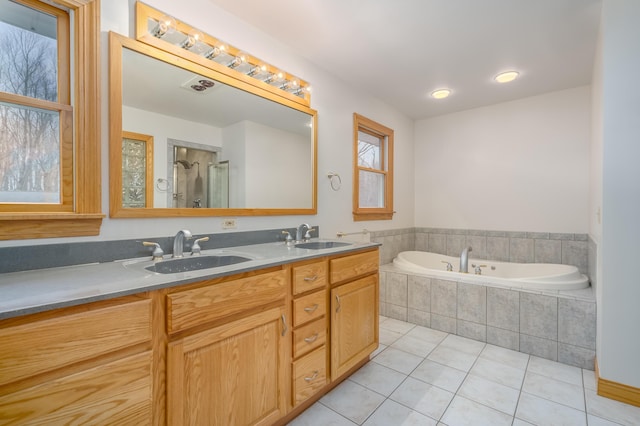 bathroom featuring tile patterned floors, vanity, and plus walk in shower