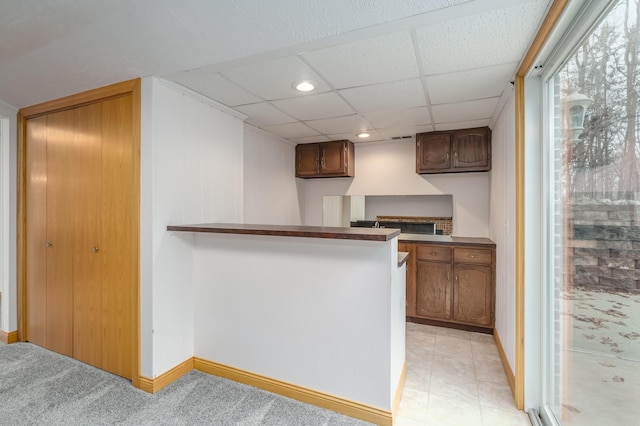 kitchen with a paneled ceiling and kitchen peninsula