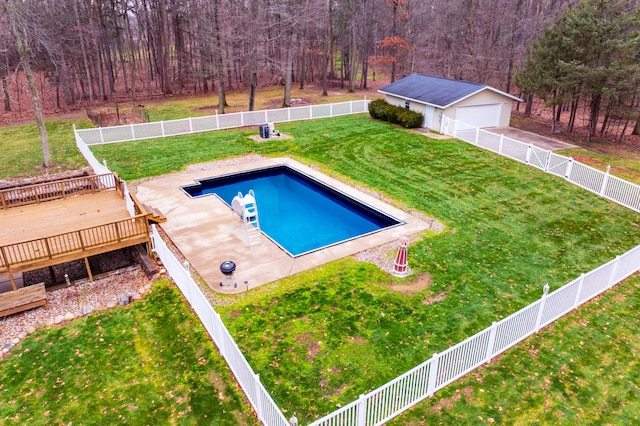 view of swimming pool with an outbuilding, a yard, and a wooden deck