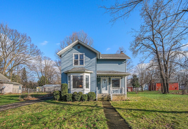 front of property with covered porch and a front lawn