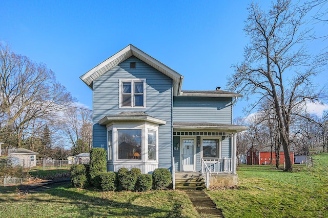 view of front property featuring a front lawn and covered porch