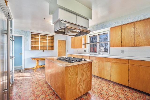 kitchen featuring wooden counters, island range hood, a kitchen island, and stainless steel gas stovetop