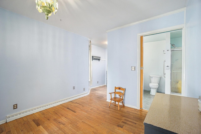 interior space featuring ornamental molding, a baseboard radiator, and hardwood / wood-style flooring