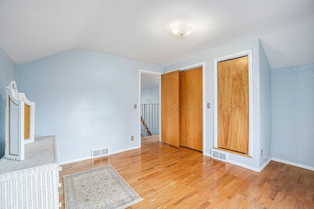 interior space featuring lofted ceiling and light wood-type flooring