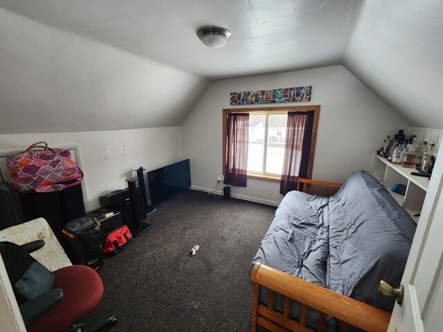 additional living space featuring vaulted ceiling and dark colored carpet