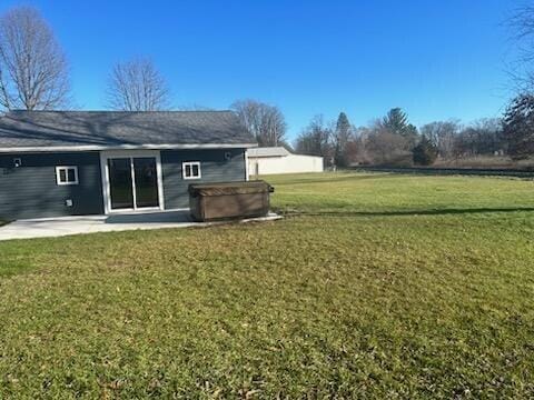 view of yard featuring a patio area and a hot tub