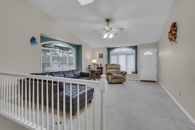 living room featuring light colored carpet, ceiling fan, and lofted ceiling