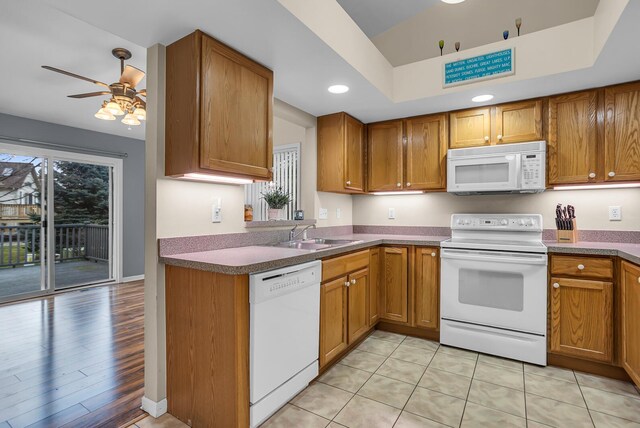 kitchen with ceiling fan, sink, white appliances, and light hardwood / wood-style flooring