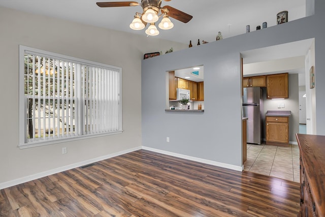 interior space with vaulted ceiling, light hardwood / wood-style flooring, and ceiling fan