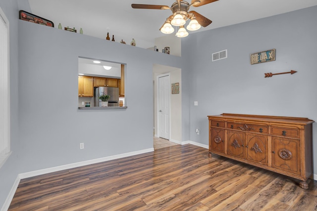 unfurnished room featuring ceiling fan and dark hardwood / wood-style flooring