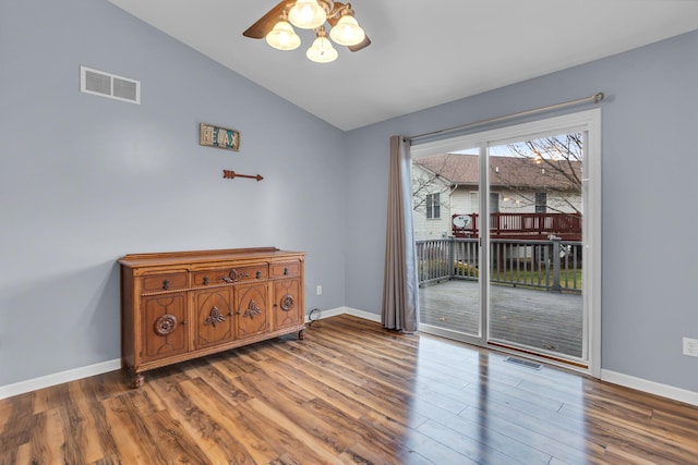 empty room featuring hardwood / wood-style floors, ceiling fan, and lofted ceiling