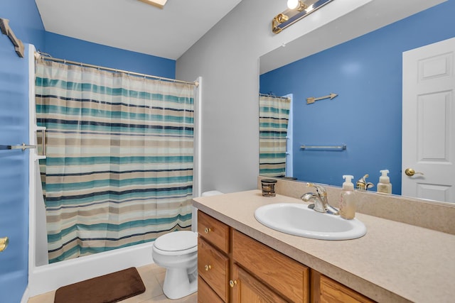 bathroom featuring curtained shower, tile patterned flooring, vanity, and toilet