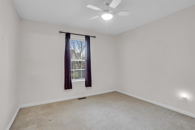 unfurnished room featuring light carpet and ceiling fan