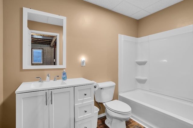 full bathroom with shower / bathing tub combination, vanity, wood-type flooring, and toilet