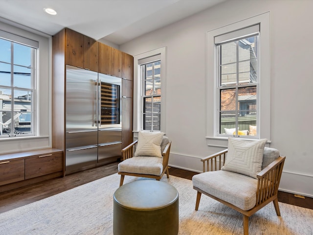 sitting room with hardwood / wood-style flooring and a wealth of natural light