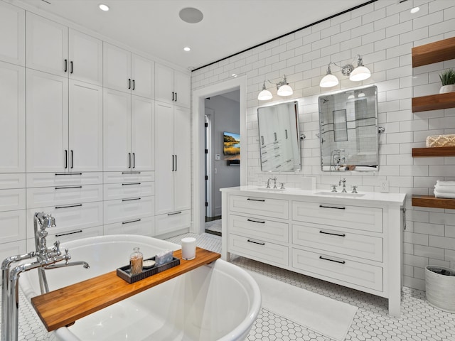 bathroom with a washtub, tile patterned floors, and tile walls