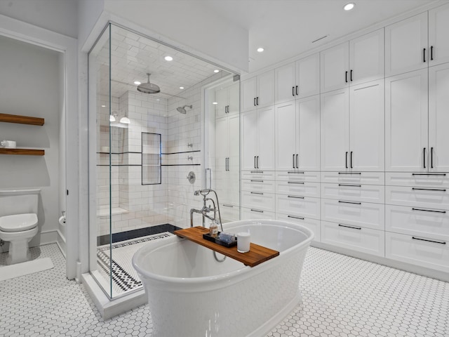 bathroom with tile patterned flooring, toilet, and independent shower and bath