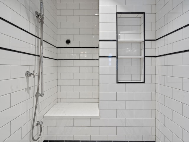 bathroom with a tile shower