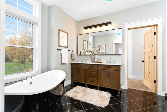 bathroom with vanity, tile patterned floors, and a tub