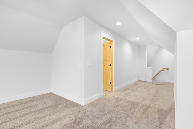 bonus room featuring light colored carpet and lofted ceiling