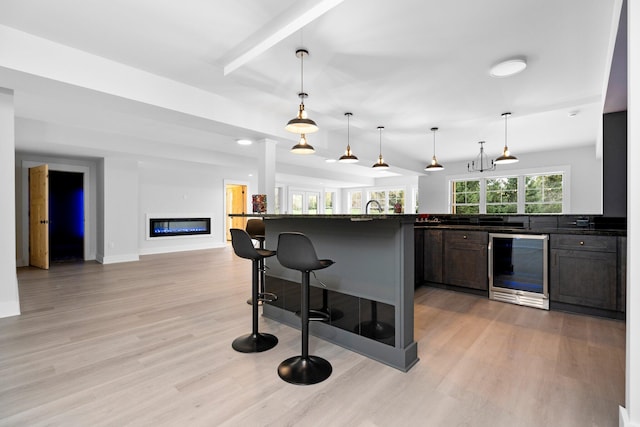 kitchen with a breakfast bar, light wood-type flooring, and a wealth of natural light